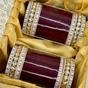 Elevate your bridal look with our exquisite Maroon Chooda Set, featuring a stunning combination of dotted and pearl bangles.