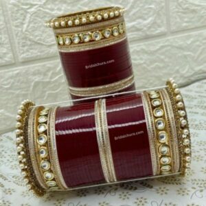 Elevate your traditional attire with the Royal Pearl Kundan Chura, a stunning set of bangles that exudes elegance and sophistication.